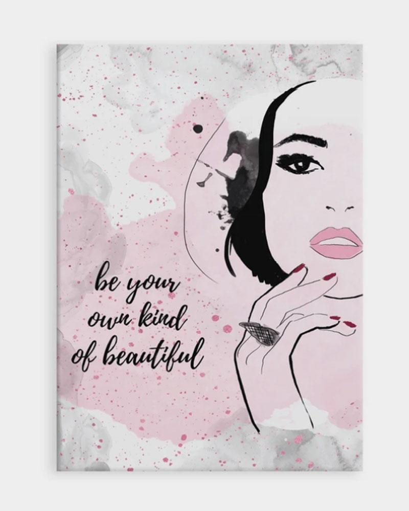 A black and white art print with the words be your own kind of beautiful written in cursive beside an elegant woman with pink lipstick